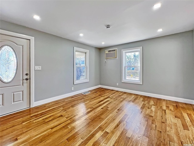 entryway with an AC wall unit and light wood-type flooring