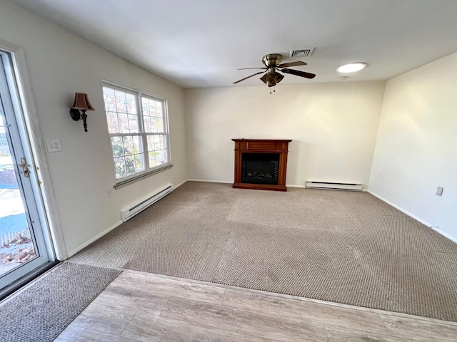 unfurnished living room featuring a baseboard heating unit, light carpet, and ceiling fan