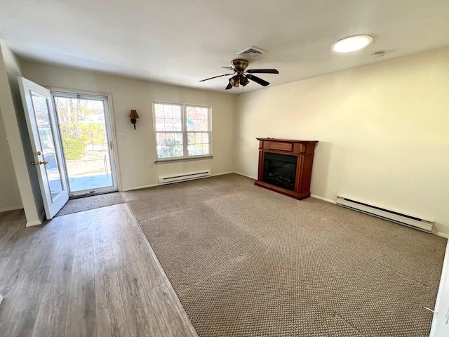 unfurnished living room featuring ceiling fan, hardwood / wood-style floors, and baseboard heating