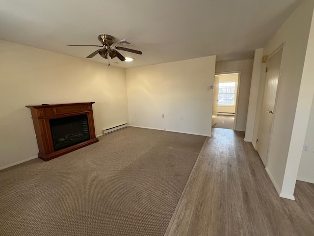 unfurnished living room featuring wood-type flooring, ceiling fan, and baseboard heating