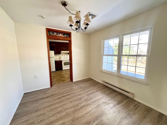 unfurnished dining area featuring a notable chandelier, hardwood / wood-style floors, and baseboard heating