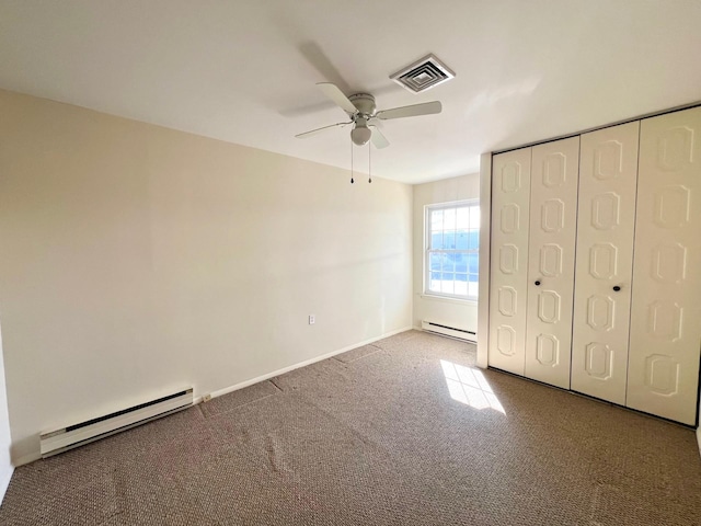 unfurnished bedroom featuring a baseboard radiator, a closet, ceiling fan, and carpet