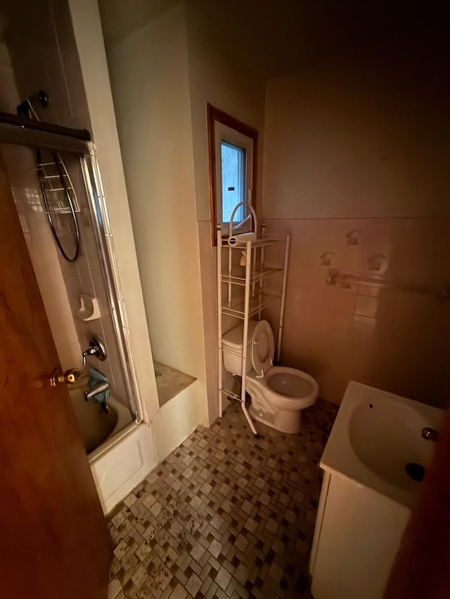 full bathroom with vanity, shower / bath combination with glass door, and toilet