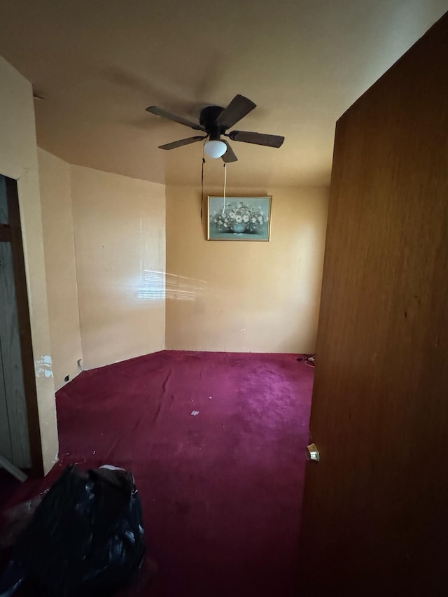 unfurnished room with ceiling fan and carpet floors