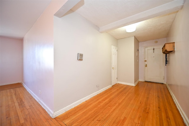 interior space with light hardwood / wood-style floors and a textured ceiling