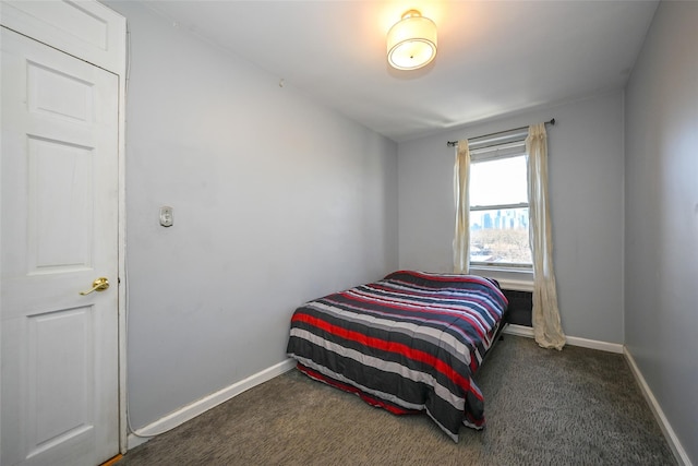 bedroom featuring dark colored carpet