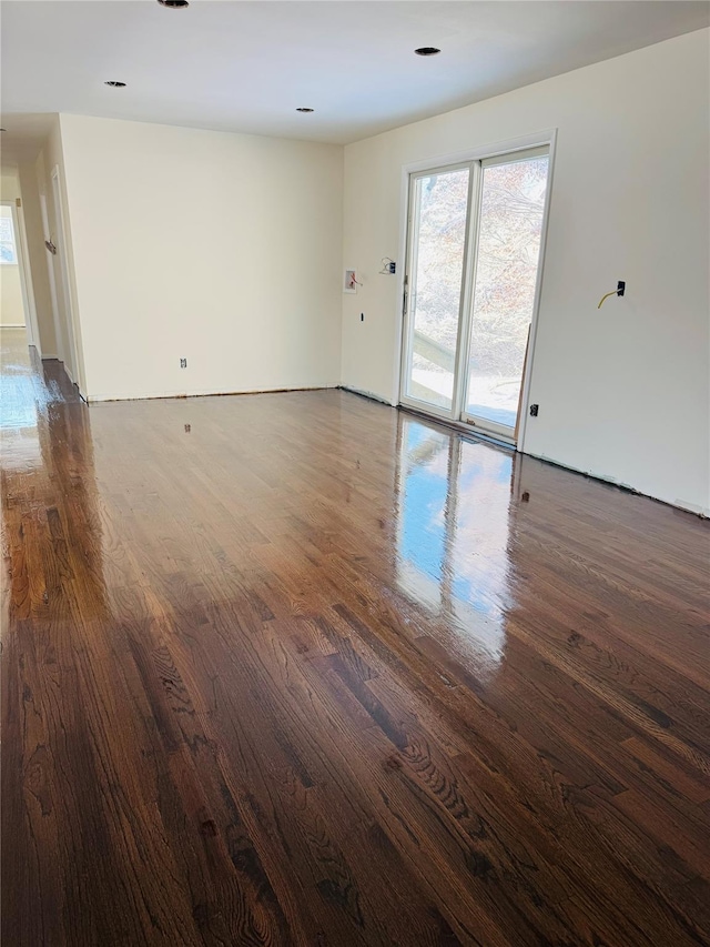 spare room with dark wood-type flooring