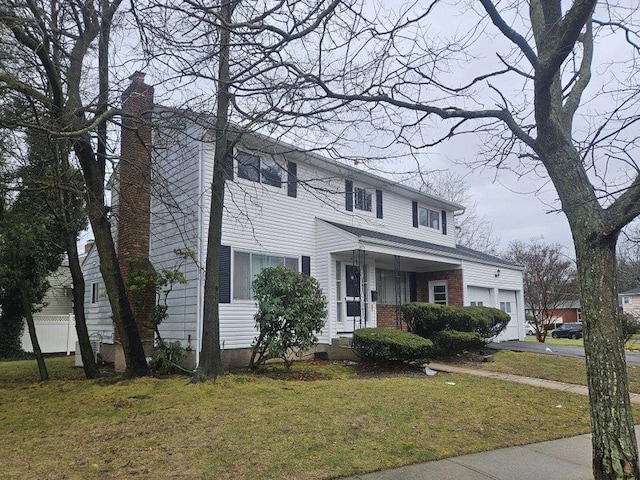 view of front of house with a garage and a front yard