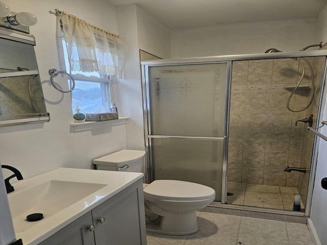 bathroom featuring vanity, an enclosed shower, tile patterned floors, and toilet