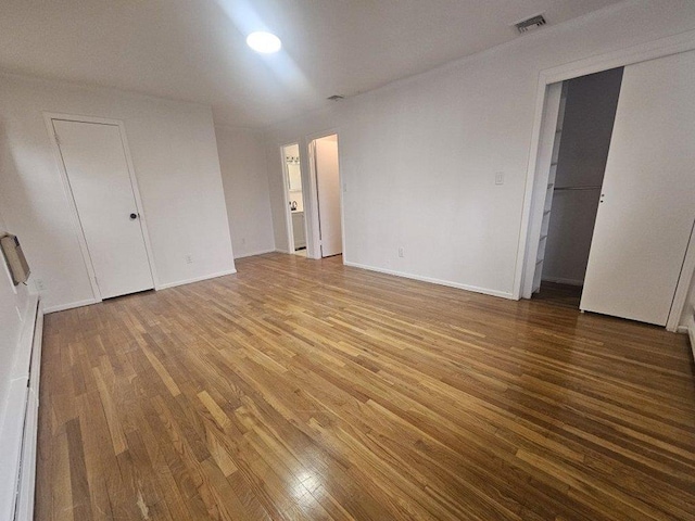 unfurnished bedroom featuring hardwood / wood-style flooring