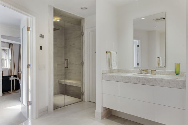 full bathroom featuring visible vents, a shower stall, and vanity