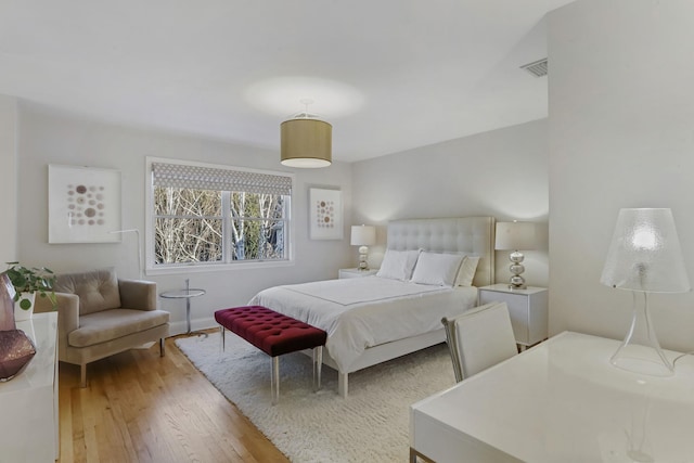 bedroom with hardwood / wood-style flooring and visible vents