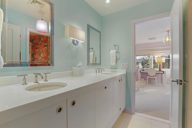 full bathroom featuring double vanity, visible vents, a sink, and tile patterned floors