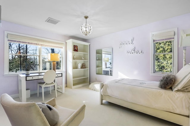 bedroom featuring carpet, multiple windows, visible vents, and a chandelier