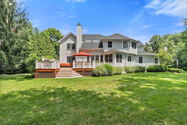 back of house featuring a deck, a yard, and a chimney