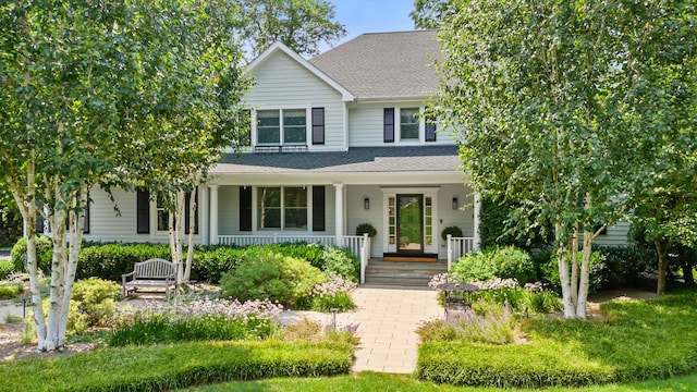 view of front of house featuring a shingled roof and a porch