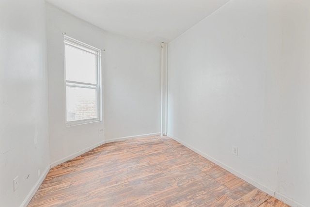 empty room with hardwood / wood-style flooring