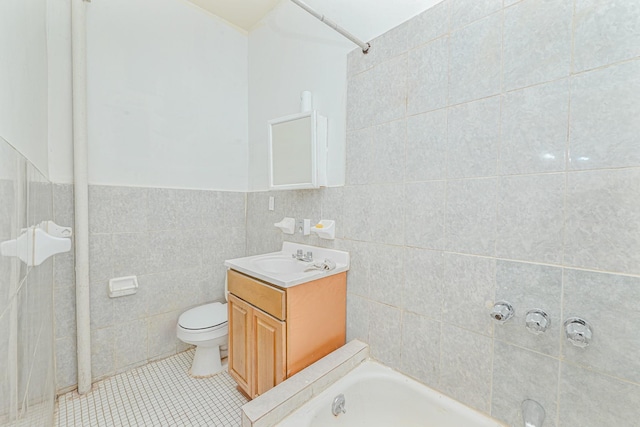 bathroom with tile patterned flooring, vanity, tile walls, and toilet