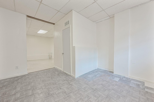 unfurnished room featuring a paneled ceiling and light parquet floors