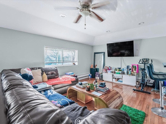 living room with hardwood / wood-style flooring, ceiling fan, and baseboard heating