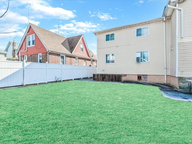 rear view of house with a yard