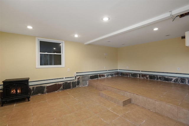 tiled empty room with a wood stove and baseboard heating