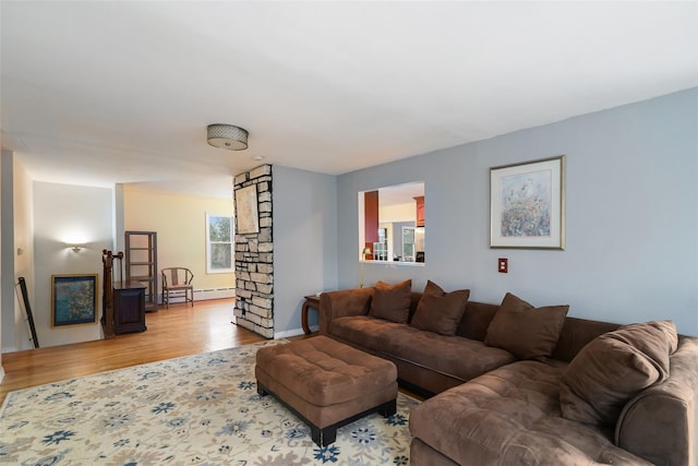 living room with a baseboard radiator and light hardwood / wood-style floors