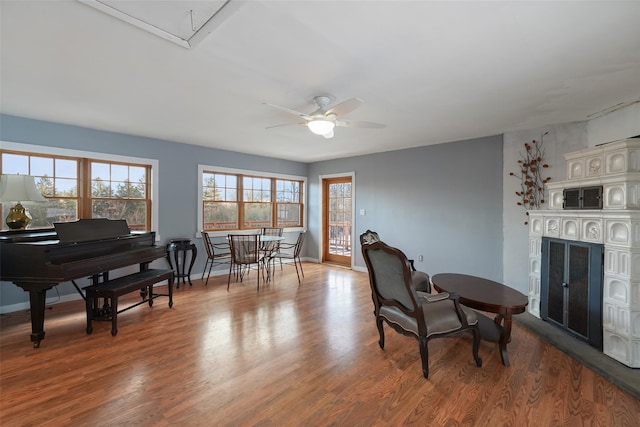 living area with ceiling fan and light hardwood / wood-style flooring