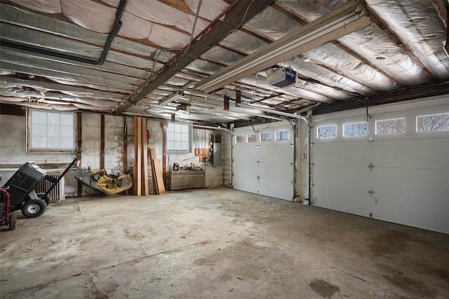 garage with a garage door opener and electric panel