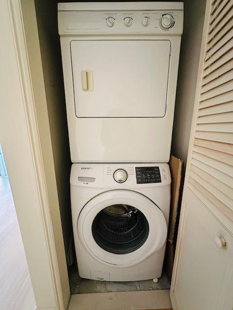 laundry room with stacked washer / dryer