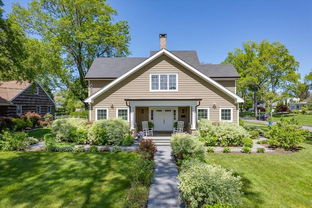 4 Clover Pl, New Rochelle, NY 10805 - view of front of home with a chimney, a front lawn, and roof with shingles
