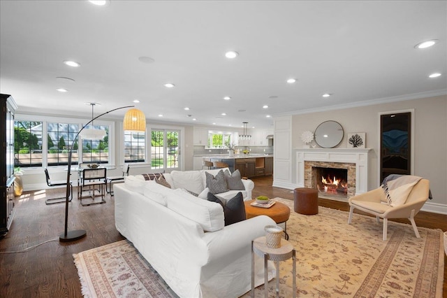 4 Clover Pl, New Rochelle, NY 10805 - living room with ornamental molding, recessed lighting, a warm lit fireplace, dark wood-style flooring, and baseboards