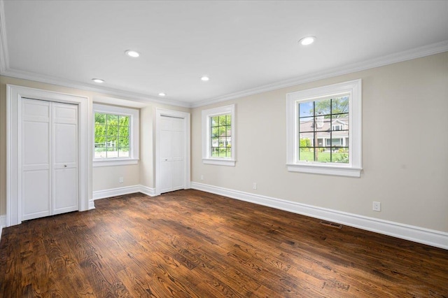 4 Clover Pl, New Rochelle, NY 10805 - unfurnished bedroom featuring crown molding, dark wood-style flooring, multiple closets, baseboards, and recessed lighting