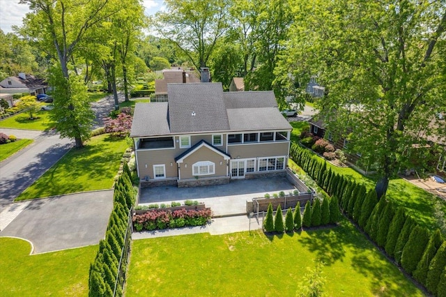 4 Clover Pl, New Rochelle, NY 10805 - back of house with a chimney, a shingled roof, and view of wooded area