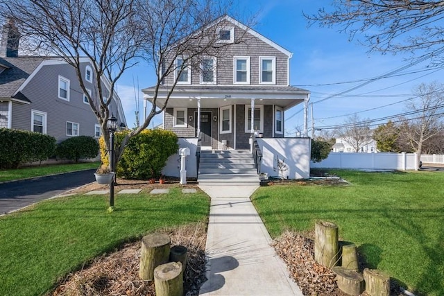 view of front of home featuring a front yard and a porch