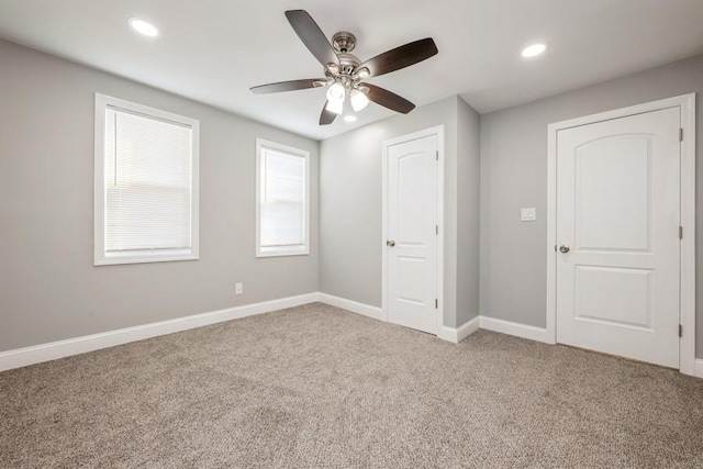 unfurnished bedroom with ceiling fan and carpet flooring