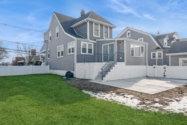 rear view of house with a yard and a patio area