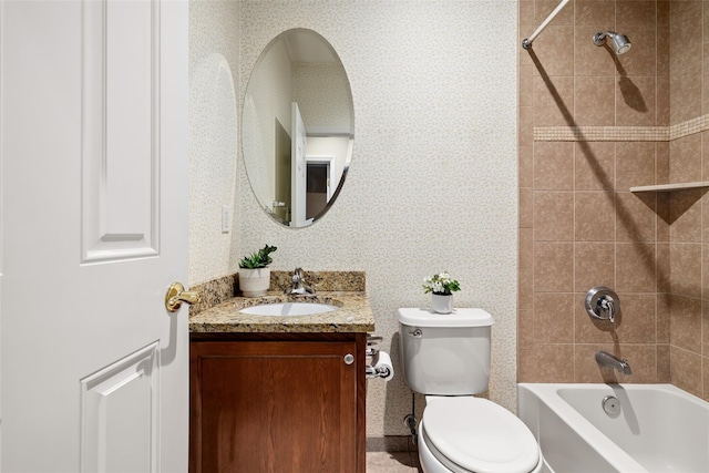 full bathroom featuring vanity, toilet, and tiled shower / bath