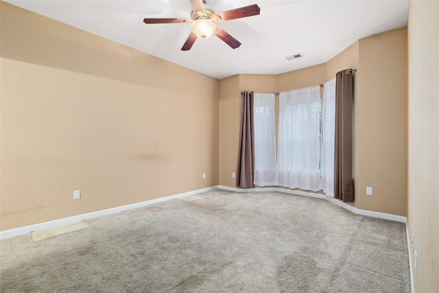 empty room with ceiling fan and light colored carpet