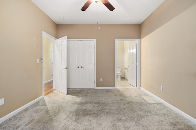 unfurnished bedroom with connected bathroom, light colored carpet, ceiling fan, and a closet