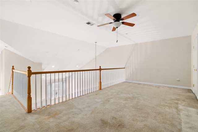 spare room featuring ceiling fan, light colored carpet, and lofted ceiling