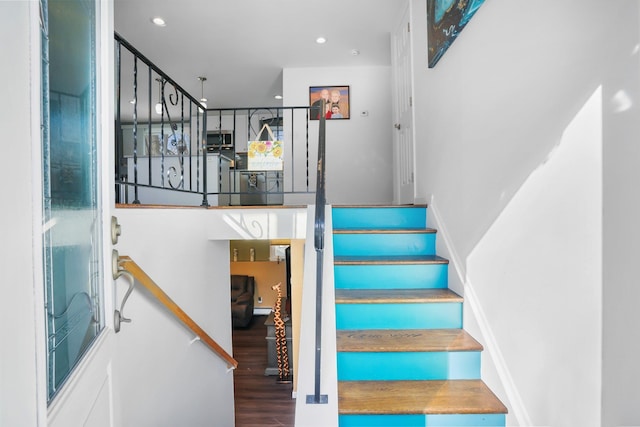 staircase with hardwood / wood-style flooring