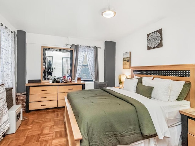 bedroom with light parquet floors