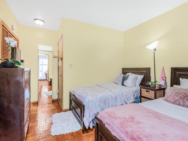 bedroom with light parquet flooring