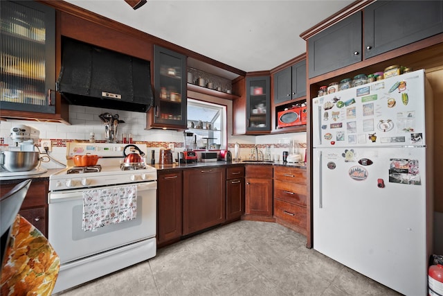 kitchen with white appliances, sink, decorative backsplash, and wall chimney range hood