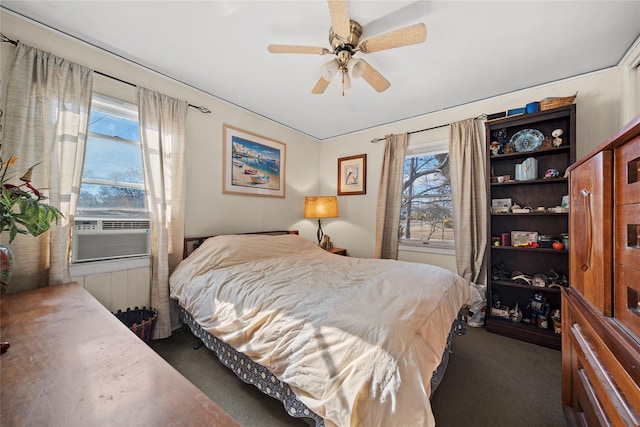 bedroom featuring multiple windows, radiator heating unit, cooling unit, and dark carpet