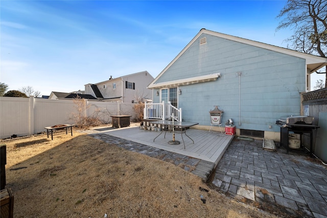 back of house with a yard, a deck, and a patio area