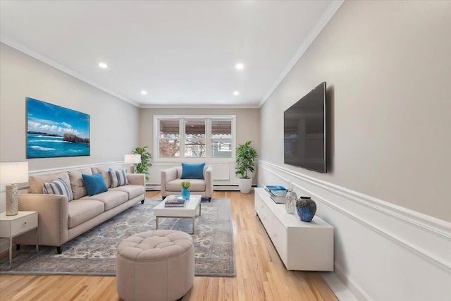 living room featuring crown molding, a baseboard heating unit, and light hardwood / wood-style floors