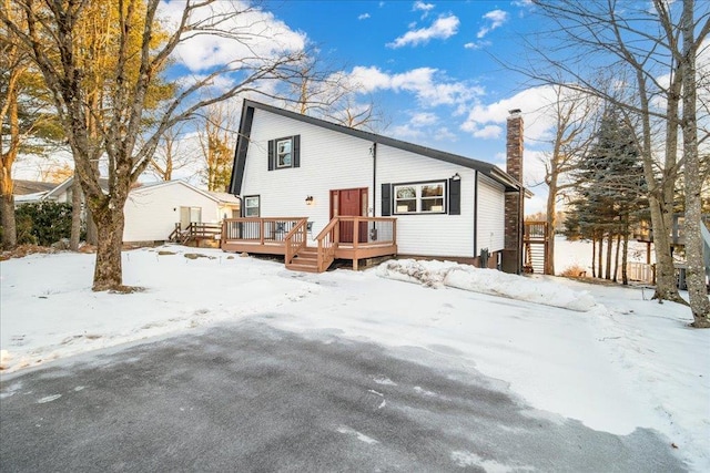 snow covered property featuring a deck