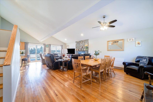 dining room with high vaulted ceiling, ceiling fan, and light hardwood / wood-style flooring